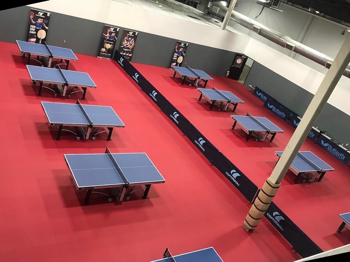 The Westford Table Tennis Club playing hall, twelve Cornilleau tables on red flooring